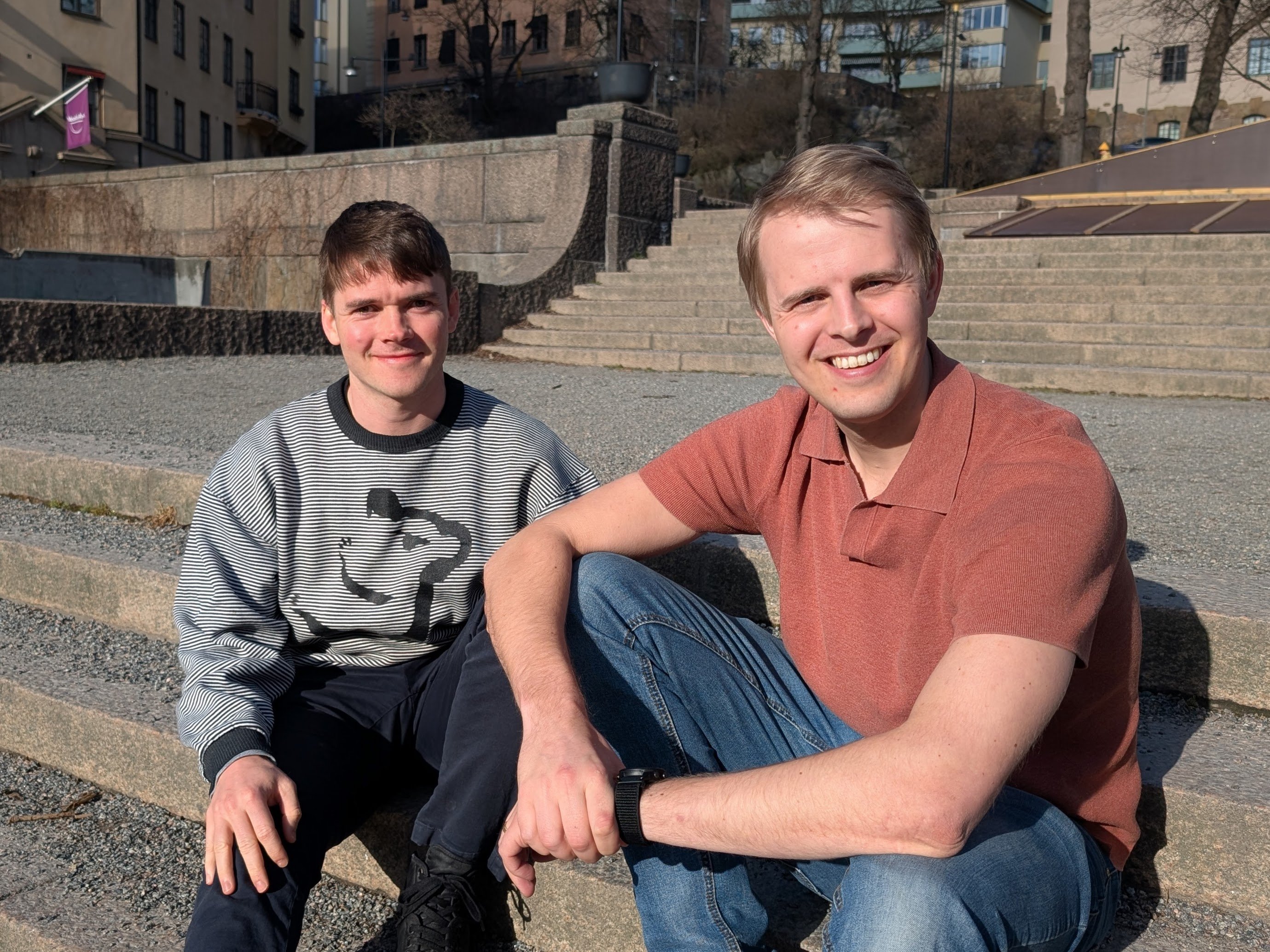 Jakob and Oliver sitting outside on a staircase